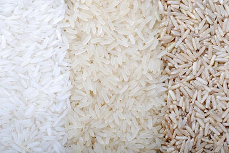 Food background with three rows of rice varieties : brown rice, mixed wild rice, white (jasmine) rice.  の写真素材
