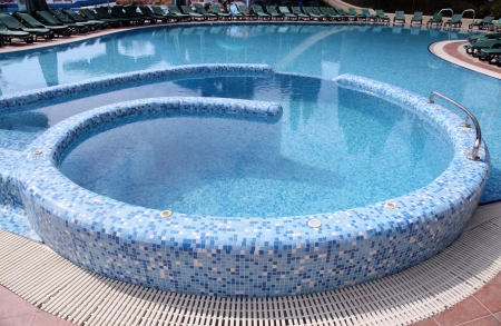 Curved blue tiled hotel resort swimming poolのeditorial素材