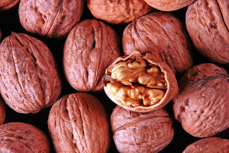 background with walnuts and one crushed walnut
