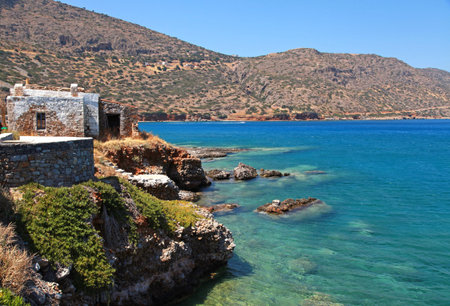 Beautiful Mediterranean sea coast with turquoise waters and scenic stone hut at Crete island, Greece.の写真素材