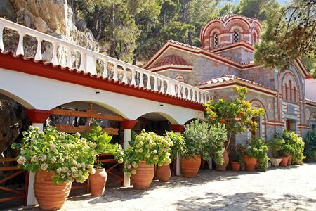 Beautiful garden with patio and flower pots in old mountain orthodox monastery(Crete, Greece)の写真素材