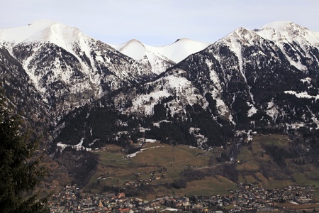 Winter Landscape with Alps Mountains, Ski Tracks and Alpine Village Bad Hofgastein in the valley(Austria)の写真素材