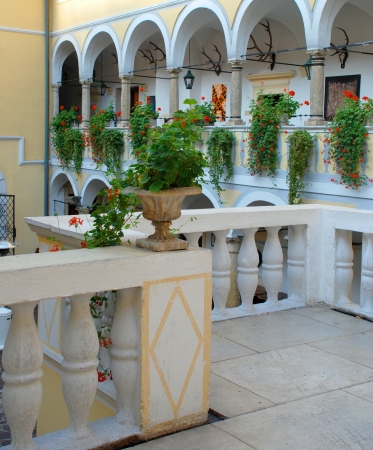 The interior of old hunting castle with white balustrade and flowers , Austriaのeditorial素材