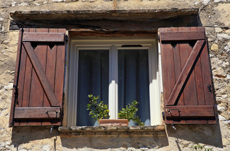french open window with old wood shutters in stone rural house, Provence, Franceの写真素材
