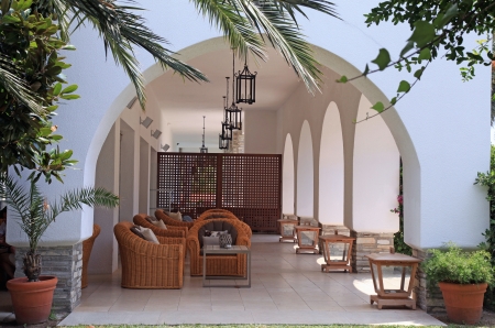 Mediterranean resort terrace with wicker armchairs in the summer tropical garden, Greeceのeditorial素材