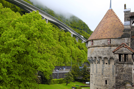 View of The Chillon Castle (Chateau de Chillon) and green Alps near Montreux, Switzerlandのeditorial素材