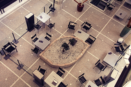 Tables and chairs in contemporary cafe, view from aboveの写真素材