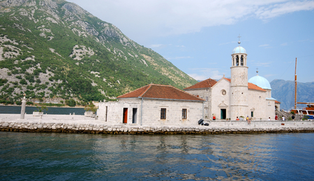 KOTOR BAY, MONTENEGRO - JULY 18, 2010: Panoramic view with tourists in famous Church Our Lady of the Rocks. Island with Church in Kotor Bay, Montenegro.のeditorial素材