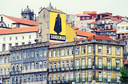 PORTO, PORTUGAL - MAY 06, 2009: View of old multicolored buildings with Sandeman Advertising Signboard,Porto, Portugalのeditorial素材