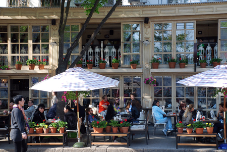 ODESSA, UKRAINE - APRIL 29, 2010: People sitting in beautiful outdoor cafe on the main street Deribasovskaya in Odessa, Ukraine .のeditorial素材