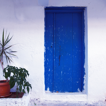 blue wood painted door at old traditional house (Crete, Greece), square toned image, instagram effectのeditorial素材