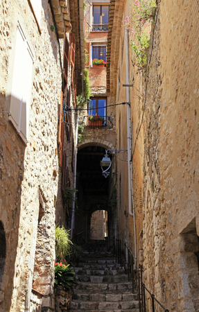 Narrow street with steps in medieval Saint Paul de Vence, one of the oldest towns of Provence, France, famous town of painters and galleriesの写真素材