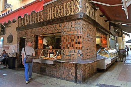 NICE, FRANCE - MAY 14, 2013: Unidentified people buying at Delicatessen stand at street food outdoor cafe in the Old town, Nice, French Riviera, Cote dのeditorial素材