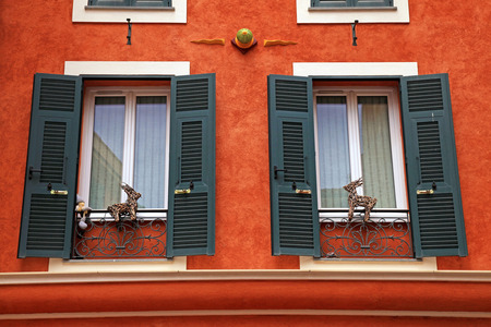 Beautiful red stucco house with old french green shutter windows, Monaco, Monte Carlo.の写真素材