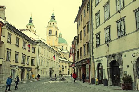 LJUBLJANA, SLOVENIA - FEBRUARY 10, 2015: Winter cityscape with Cathedral St. Nicholas Church and historic city center, Ljubljana, capital of Slovenia. Vintage toned imageのeditorial素材