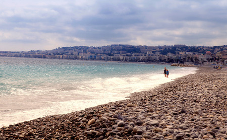 NICE, FRANCE - MAY 14, 2013: girls on beautiful beach on Promenade des Anglais in Nice, French Riviera, France. Vintage toned image, selective focusのeditorial素材