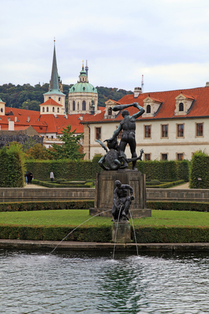 Fountain and statue in Waldstein Garden and Prague Castle, Prague, Czech Republic. Vertical imageのeditorial素材