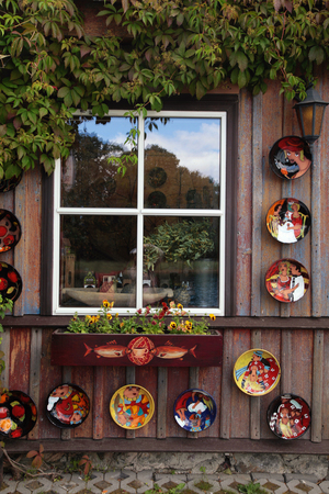 rustic window with ceramic plates and flower pot in wood rural house, Vilniusの写真素材