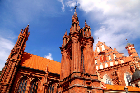 Detail of gothic St. Anne's Church and the Church of St. Francis from Assisi (Historical-architectural ensemble of Bernardines), Vilnius, Lithuania on blue sky background.の写真素材