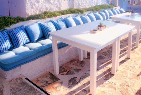 Beautiful terrace with white relax sofa and blue pillows , Crete, Greece. Selective focusの写真素材