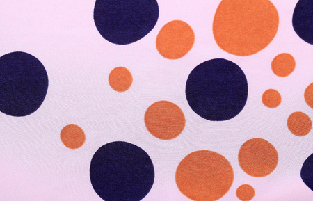 Closeup of silk texture background textile with blue and orange polka dotsの写真素材