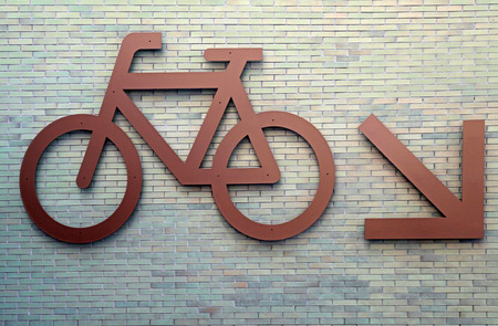 Bike route urban sign on brick wallの写真素材