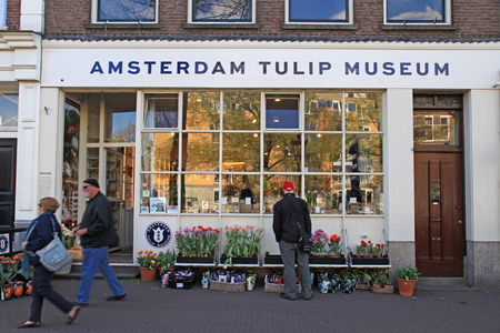 AMSTERDAM, NETHERLANDS - MAY 3, 2016: Unknown people in the front of the Amsterdam Tulip Museum, Amsterdam, Netherlands.のeditorial素材