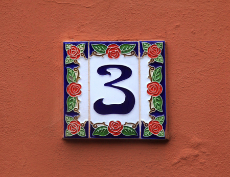 Home ceramic tile with number 3 mounted on stone facade, Italyの写真素材