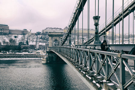 BUDAPEST, HUNGARY - JANUARY 5, 2016: People on The Szechenyi Chain Bridge in Budapest, Hungary. The Szechenyi Chain Bridge is a suspension bridge that spans the River Danube between Buda and Pest.のeditorial素材