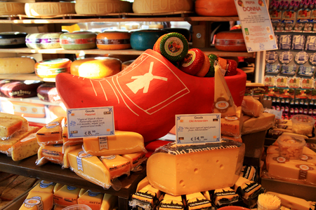AMSTERDAM, NETHERLANDS - MAY 3, 2016: Display of traditional Dutch cheese, like Edam and Gouda cheese on a table at local cheese shop, Amsterdam, the Netherlands. Selective focusのeditorial素材