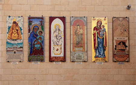 NAZARETH, ISRAEL - AUGUST 30, 2015: The beautiful icon mosaics of Madonna and the Child in different cultural styles on the wall of the Basilica of Annunciation in Nazareth, Israel.のeditorial素材