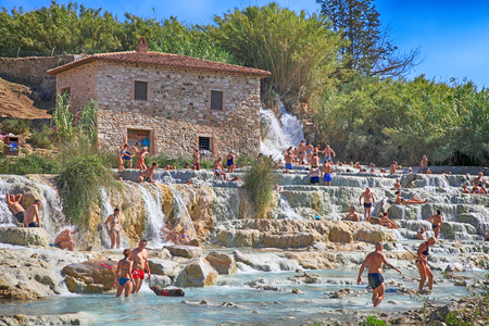 SATURNIA, ITALY - JULY 26, 2017: Natural spa with waterfalls and hot springs at Saturnia thermal baths, Grosseto, Tuscany, Italy. Tourists swimming and relaxing in hot springs at Cascate del Mulino in Saturniaのeditorial素材