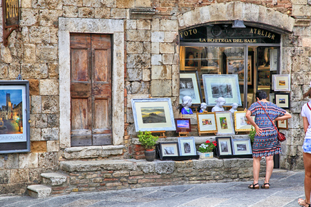 SAN GIMIGNANO, ITALY - JULY 22, 2017 : Tourists in the gift shop at the medieval town of San Gimignano, Siena, Tuscany, Italyのeditorial素材