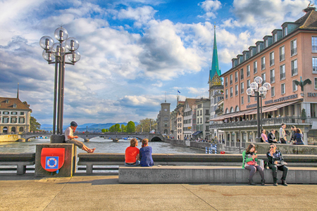 ZURICH, SWITZERLAND - MAY 5, 2013: People sitting and relax on the bridge of river Limmat in the historic city center of Zurich, Switzerland.のeditorial素材