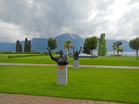 MONTREUX, SWITZERLAND - MAY 09, 2013: Landscape with Alps, lake Geneva and statue to Aretha Franklin, designed by Italian artist Marco Zeno, stands in the garden of the Montreux Palace in Montreux, Switzerlandのeditorial素材