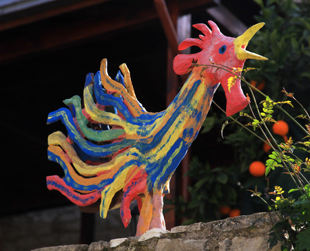 ceramic rooster figure sculpture, colorful cock statue in garden. selective focusの写真素材