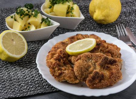 Pork schnitzel with lemon and diced potatoes