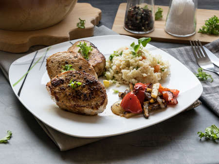 Pork medallions with grilled vegetables and vegetable couscous. Excellent foodの写真素材