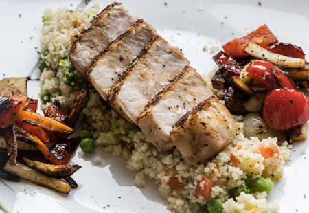 Pork medallions with grilled vegetables and vegetable couscous. Excellent foodの写真素材