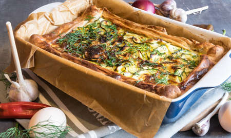 Great homemade baked zucchini cake with dill and sour creamの写真素材