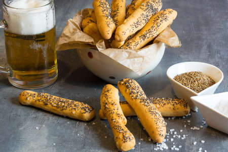Homemade salty pastry with salt and poppy seeds. Excellent as a complement to beerの写真素材