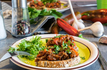 Beef meat with tomatoes and pepper on fried bread, herbaceous. Great dinnerの写真素材