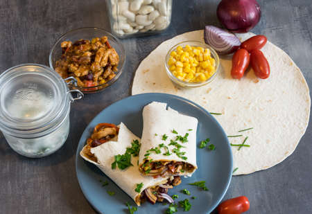 Wheat tortilla with a mixture of pork, beans, red onion and cornの写真素材