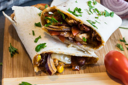 Wheat tortilla with a mixture of pork, beans, red onion and cornの写真素材