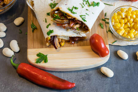 Wheat tortilla with a mixture of pork, beans, red onion and cornの写真素材