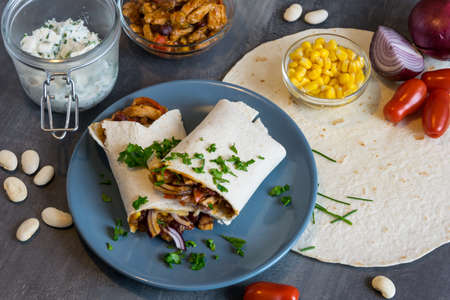 Wheat tortilla with a mixture of pork, beans, red onion and cornの写真素材