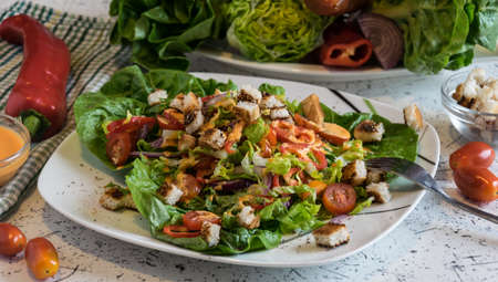 fresh vegetable salad with crunchy croutons and French dressingの写真素材
