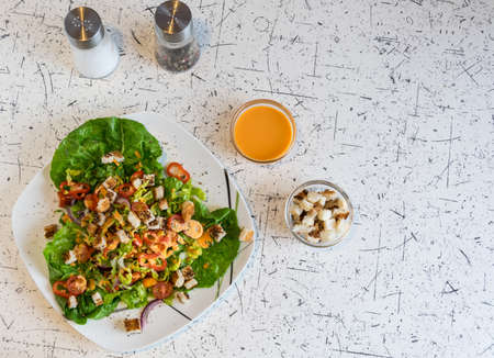 fresh vegetable salad with crunchy croutons and French dressingの写真素材