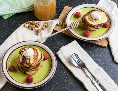 homemade pancakes with pieces of walnuts, honey and fruitの写真素材