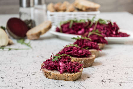 Tzatziky from red beet and cottage cheese. Decorated with fresh rucolaの写真素材